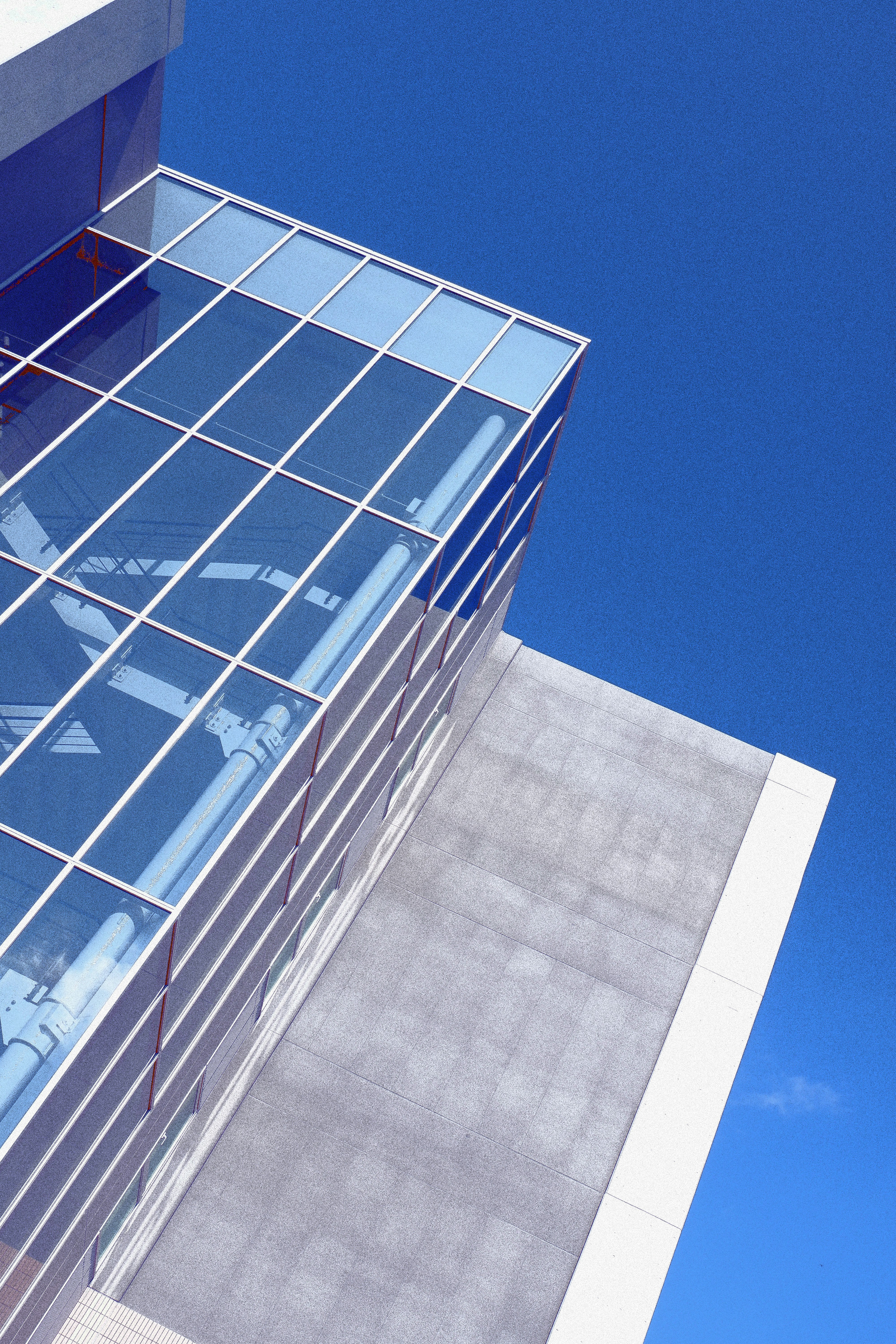 low-angle photography of white and blue glass walled high-rise building